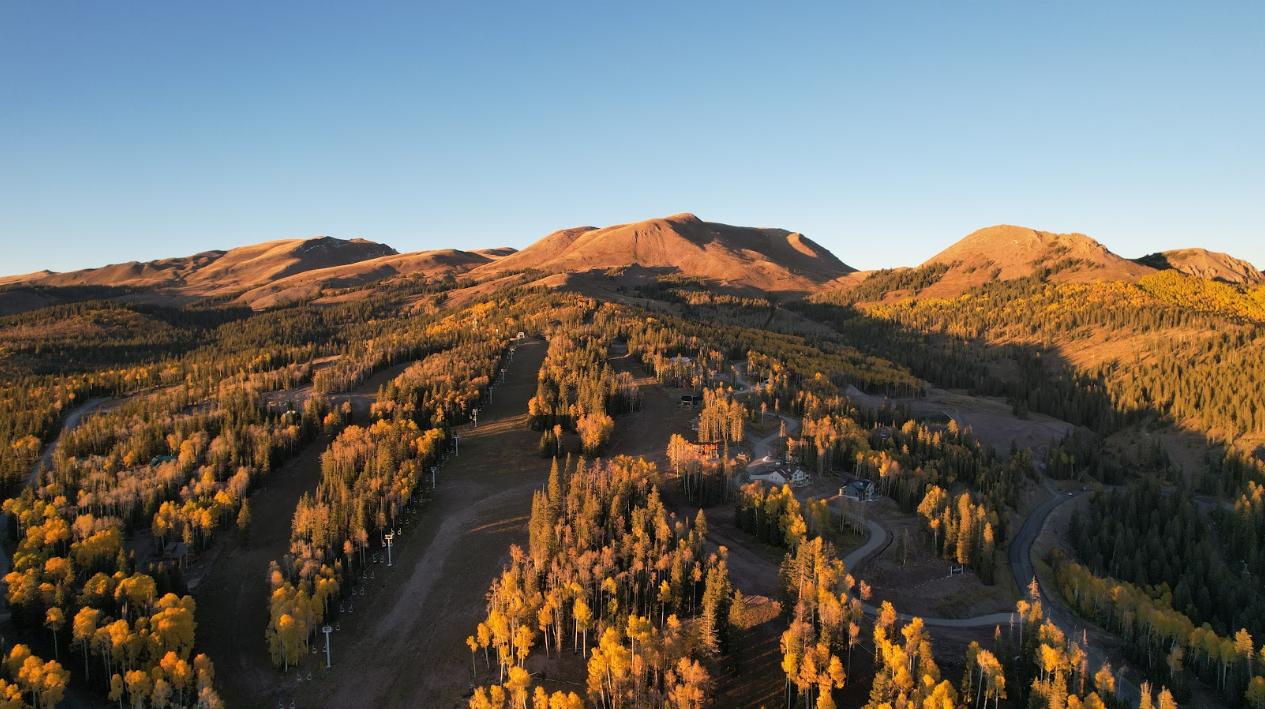 Aerial view of the Tushar Mountains with golden aspen and ski slopes at sunrise